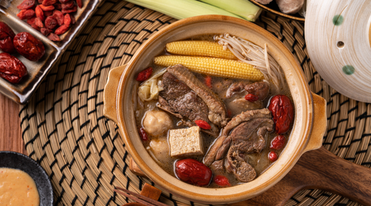 A traditional Asian winter soup with beef, red dates, corn, and root vegetables, served in a clay pot.