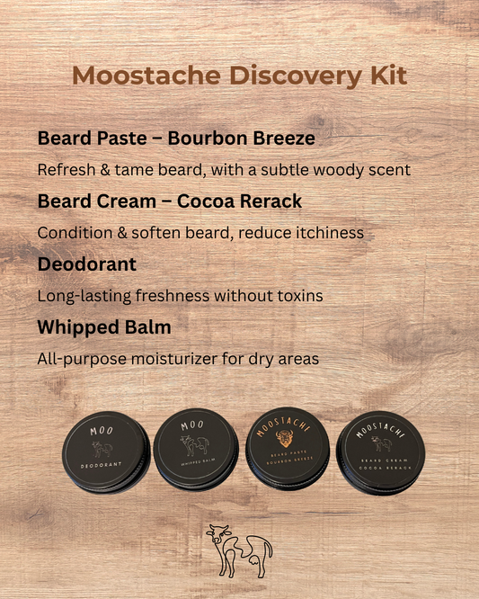 Moostache Discovery Kit product overview on a wooden background, featuring Beard Paste Bourbon Breeze, Beard Cream Cocoa Rerack, Deodorant, and Whipped Balm — natural grooming essentials for men.